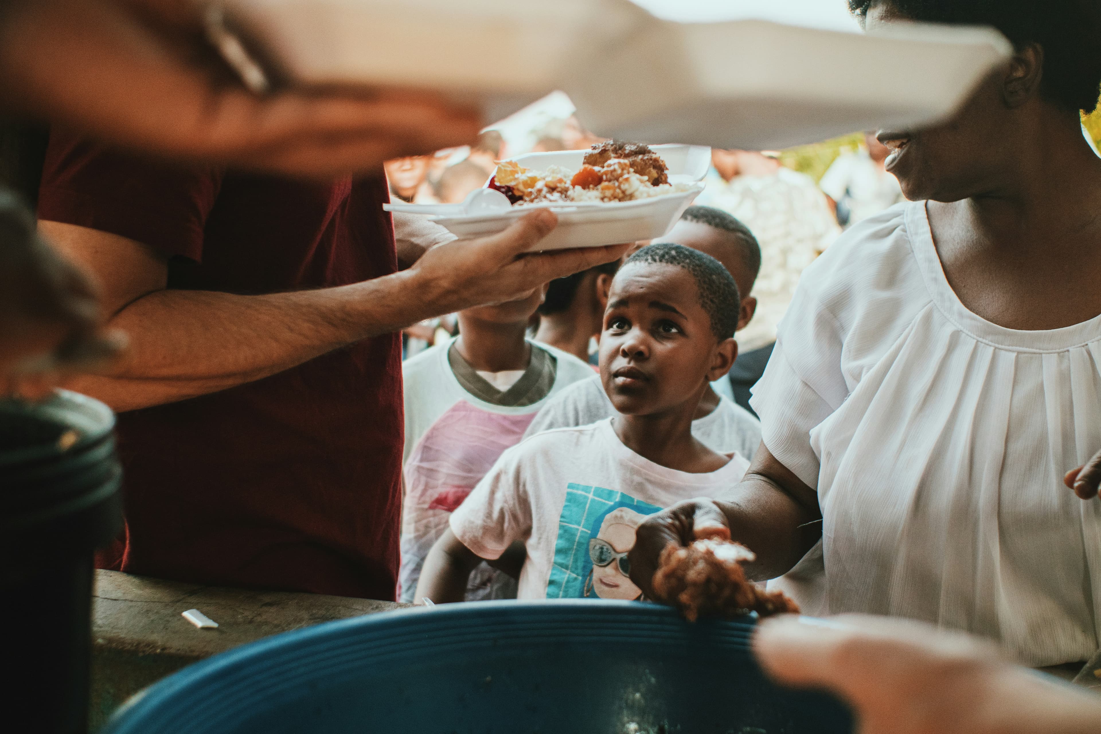 Volunteers handing out plates of freshly served food